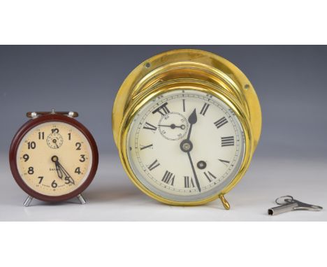 Swiza Bakelite alarm clock in original box and a brass ship's bulkhead type clock with subsidiary dial and key, diameter 14cm