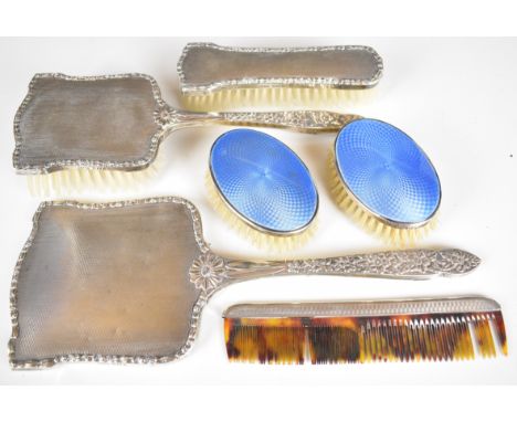 Hallmarked silver mounted dressing table items comprising hand mirror, four bushes incluidng two blue guilloch&eacute; enamel