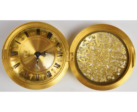 Jaeger 'Recital' eight day travelling alarm clock in gilt pierced metal case with gilt dial, calendar aperture and Roman nume