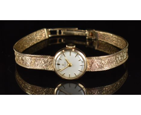 Tissot 9ct gold ladies wristwatch with gold hands and hour markers, silver dial and signed 17 jewel movement, on 9ct gold bra