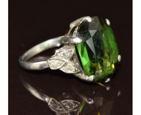 Art Deco platinum ring set with an oval cut tourmaline of approximately 6ct&nbsp;and three diamonds to each shoulder, 5.1g, s