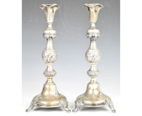 Pair of 19th century Polish silver candlesticks with embossed and engraved decoration, with 84 Russian style silver marks and