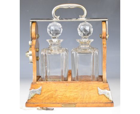 Betjemann's patent oak two bottle 'The Tantalus' with 'Scotch' hallmarked silver bottle ticket, W21 x H27cm
