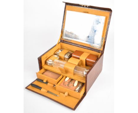 Vintage travelling vanity case with bevelled glass mirror, silver plate topped bottles, manicure set and drawer for jewellery