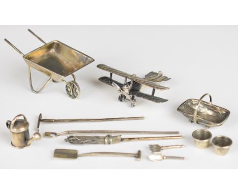 Novelty hallmarked silver items comprising WW1 or similar biplane, and a gardening set made up of a wheelbarrow, rake, hoe, s