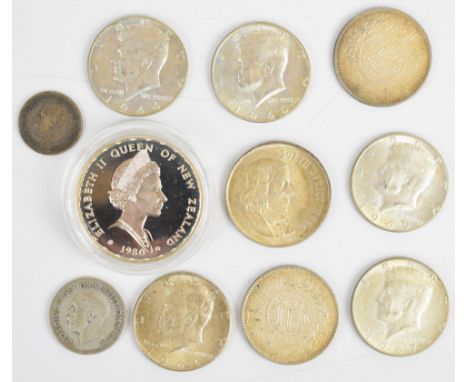 New Zealand fan tail one Dollar silver coin, five United States of America Kennedy half Dollars, two Saudi Arabia 0.917 silve