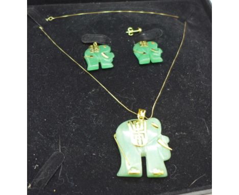 A large jade elephant pendant on a 9ct gold chain and matching earrings, boxed 