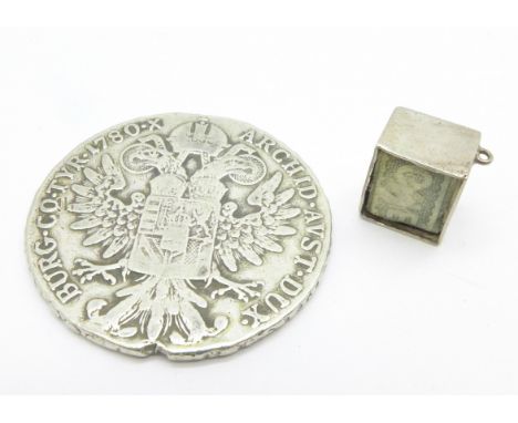 A silver one pound note charm and a 1780 Marie Theresia silver coin 