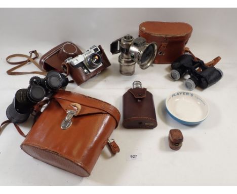 A box of collectables including car lamp, binoculars, camera, spirit flask etc. 