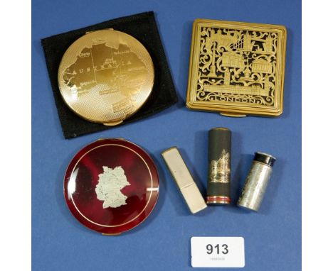 A German map enamelled compact, a London gilt metal compact, an Australian compact and three lipstick cases 