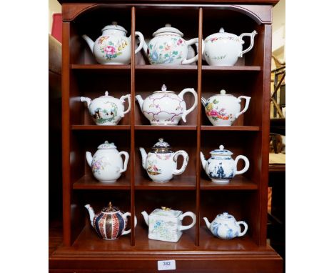 A collection of miniature teapots and wall display shelf 