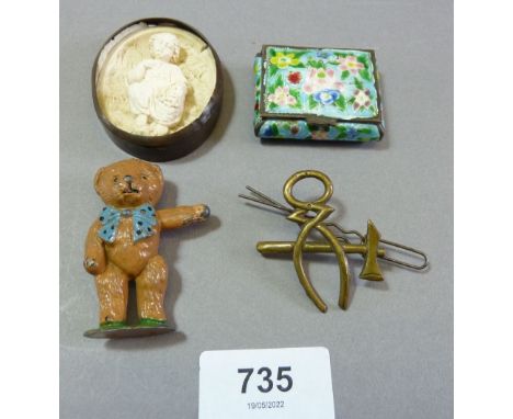 A military blacksmiths cap badge, a painted lead teddy, enamel box and plaster miniature oval