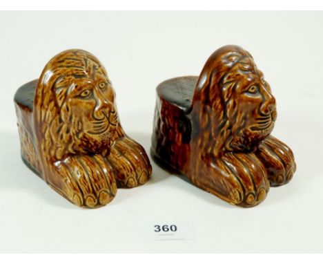 A pair of Victorian lion form pottery sash window rests 