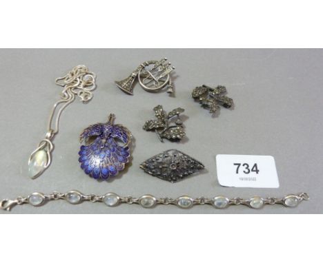 A silver and enamel Siam peacock brooch, three silver marcasite brooches, a silver and moonstone bracelet and similar necklac