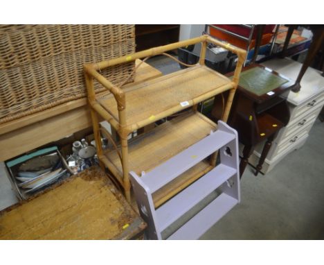 A cane three tier shelving unit together with a purple painted hanging shelf