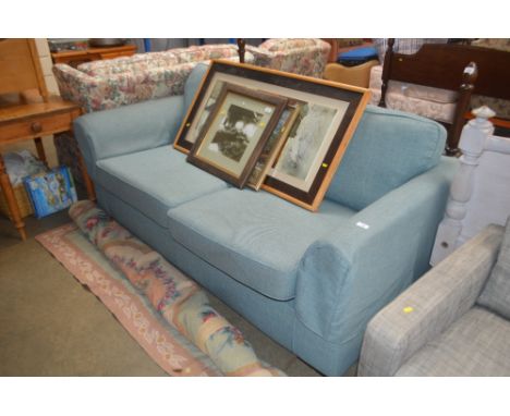 A light blue upholstered two seater settee