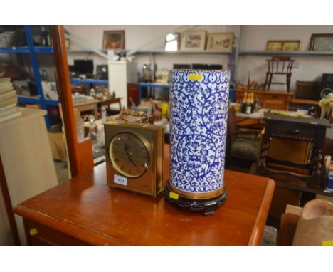 A Cloisonne vase on wooden stand together with a mantel clock