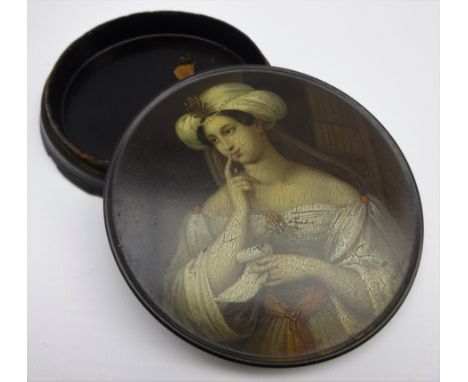 Early 19th Century Stobwasser papier mache circular snuff box the cover painted with a portrait of a Lady In a Turban holding