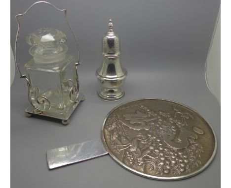 A silver plated Mappin &amp; Webb sugar sifter, an oriental mirror and glass and a silver plated pickle jar 