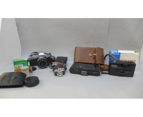 Cameras and accessories including an Olympus OM20 body, a Polaroid and a miniature novelty camera 