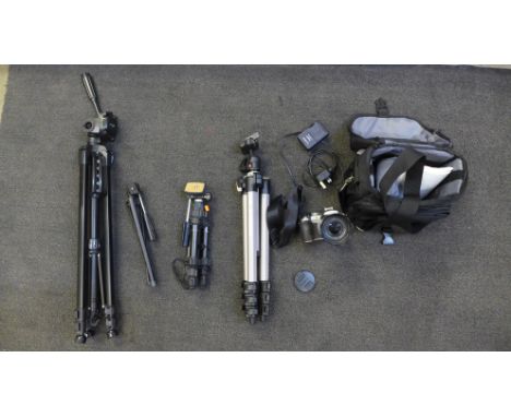 Four camera tripods, and a Panasonic Lumix DMC-FZ50 digital camera 
