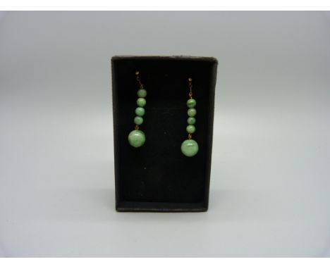 A pair of jade bead pendant earrings 