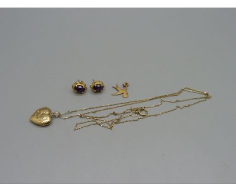 A pair of 9ct gold earrings, a 9ct gold bird charm, a 9ct gold back and front heart shaped locket on a fine 9ct gold chain, (