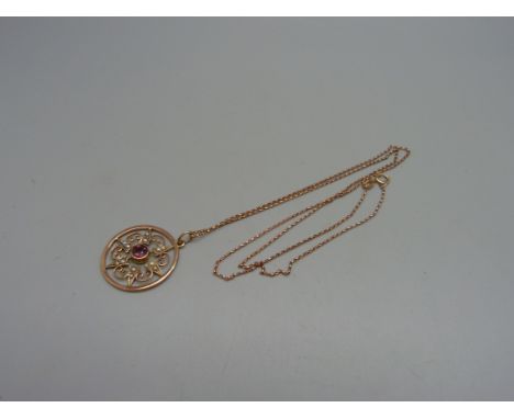 An Edwardian 9ct gold, garnet and pearl pendant on a 9ct gold chain, 3g 