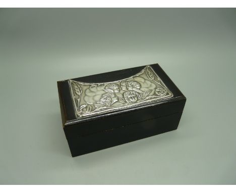A silver topped jewellery or trinket box with Reynold's Angels, 123mm wide 