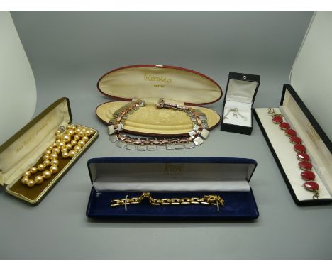 A bracelet, faux pearl necklace, pave bracelet, one other necklace and a fine chain with crystal pendant 