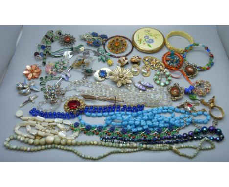 A collection of vintage costume jewellery and a compact 