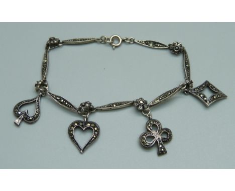 A novelty silver and marcasite bracelet with bridge playing card suite charms, 10.5g 
