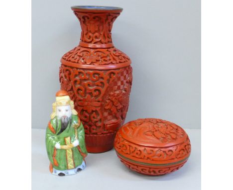 A Japanese carved cinnabar vase, lidded circular pot and a porcelain scent bottle 