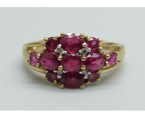 A 9ct gold, eleven ruby and four diamonds set ring, 2.4g, K 