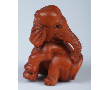 A Japanese carved Netsuke in the form of a elephant.  