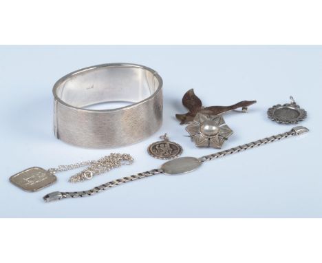 A collection of silver and white metal jewellery, to include hinged silver bangle (Birmingham, 1954, 38g) and WWII identity b