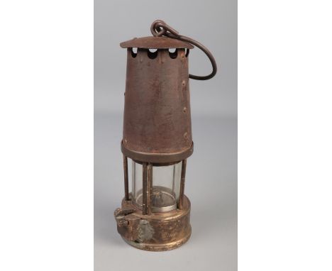 A vintage brass miners lamp with glass marked British MFP.  