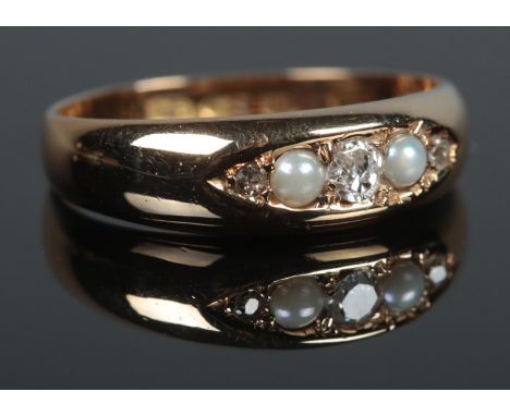 A Victorian 18ct Gold five stone Pearl and Diamond ring. Size M. Total weight: 3.3g  W.M, M.P inscribed to inside of the band