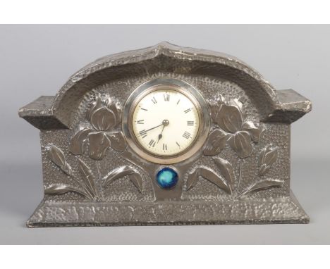 A Liberty style Art Nouveau pewter mantle clock, with hammered and floral decoration, central polished stone, French movement