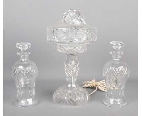 A cut glass table lamp along with pair of cut glass decanters.  