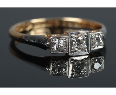 An art deco 18ct Gold, Platinum and three stone Diamond ring. Size L. Total weight: 1.9g.  