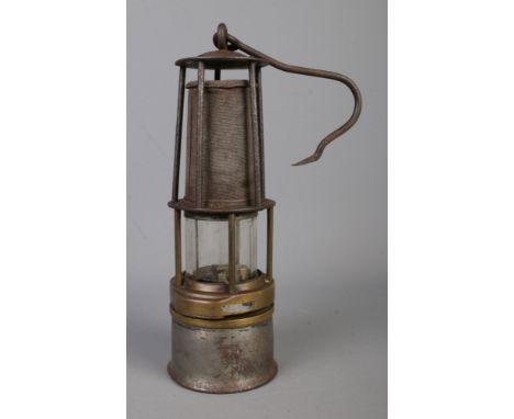 A vintage davy-type miners lamp with swing handle. Original marks have worn away.  