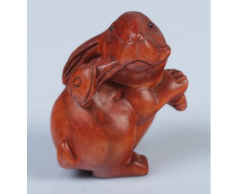 A Japanese carved Netsuke in the form of a rabbit with ruyi.  