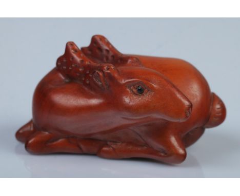 A Japanese carved Netsuke in the form of a resting deer  