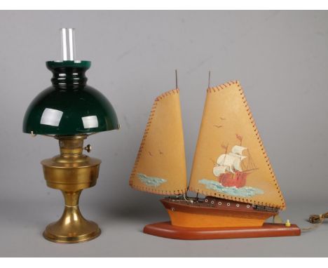 A brass oil lamp featuring green glass shade along with novelty lamp formed as a boat.  