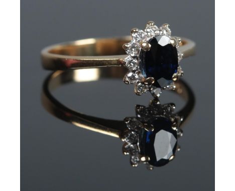 An 18ct Gold, Sapphire and Diamond cluster ring. Size K. Total weight: 2.4g  