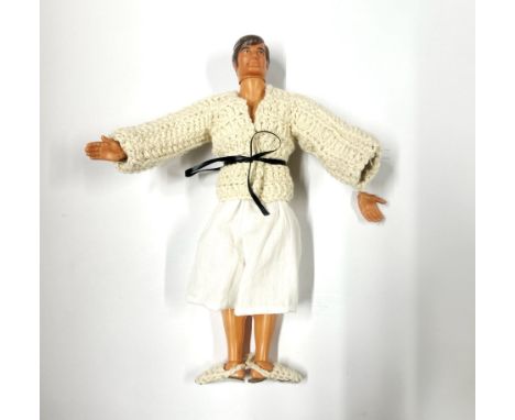 A 1970's Big Jim action figure by Mattel with a button operated arm.