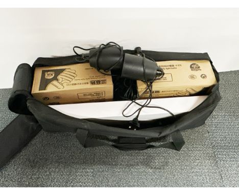 A photographic lighting kit including two tripods and filter.