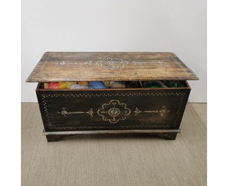 A mother of pearl inlaid wooden trunk containing a large quantity knitting yarn, 78 x 38 x 40cm.