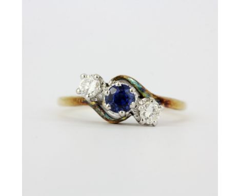 A hallmarked 18ct yellow gold ring set with a round cut sapphire and brilliant cut diamonds, estimated approx. 0.30ct total, 